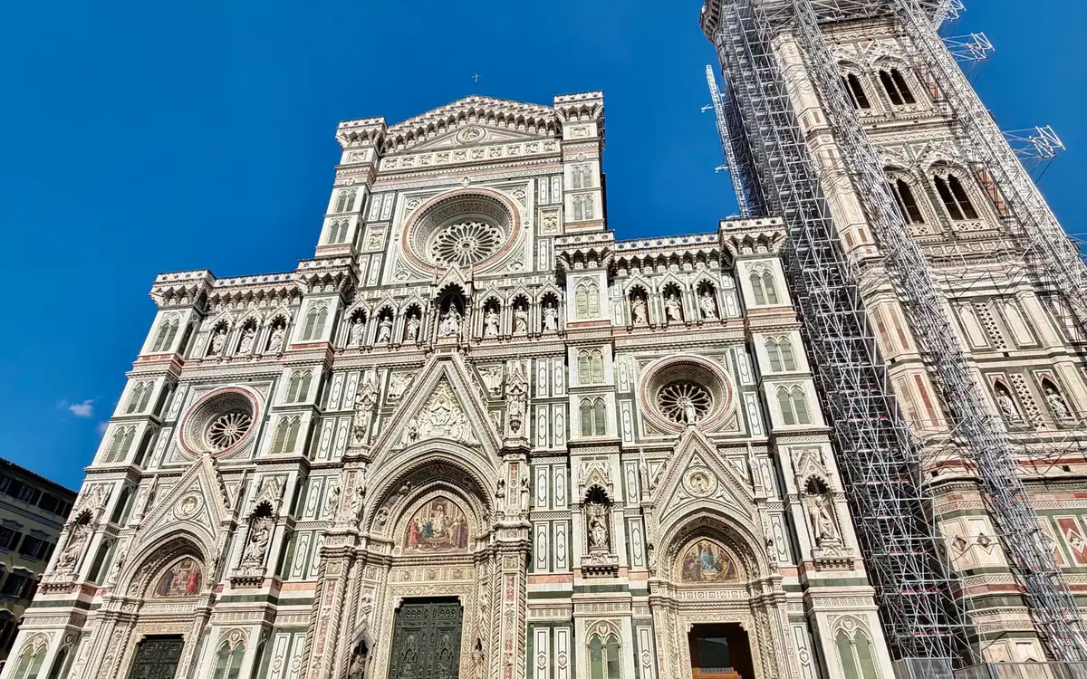 The marble front of Florence Cathedral beside Giotto&rsquo;s Bell Tower