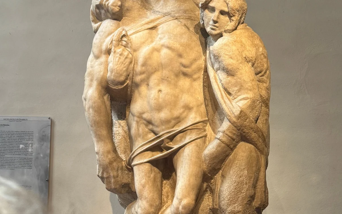 A marble Pietà: the body of Christ held upright by two figures