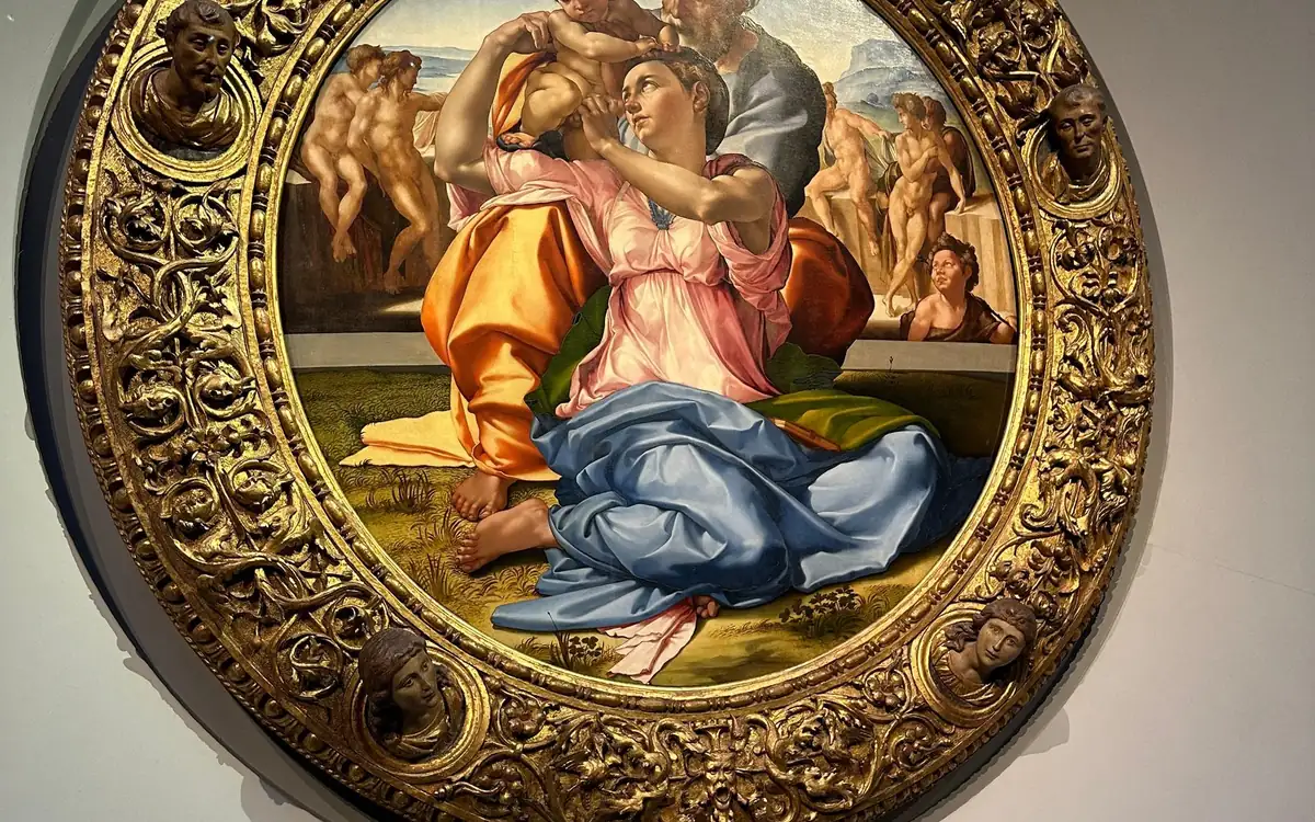 A round painting of the Holy Family in a carved gold frame