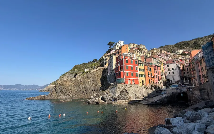 Red and orange houses on a rock above a small harbour
