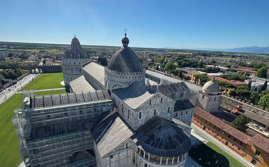 Pisa Cathedral and the Baptistery seen from above beside a green lawn