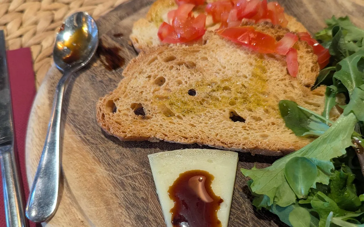Bruschetta with tomato, cheese and balsamic on a wooden board
