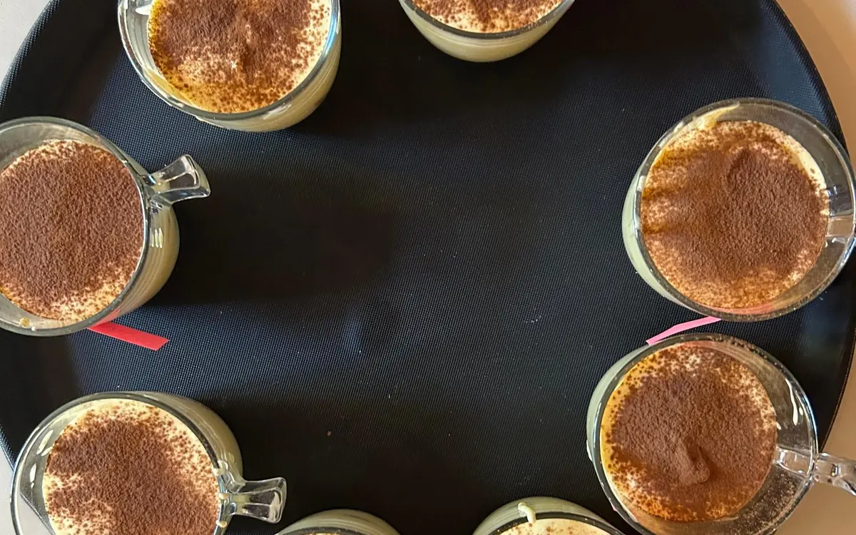 Tiramisu dusted with cocoa in glass cups