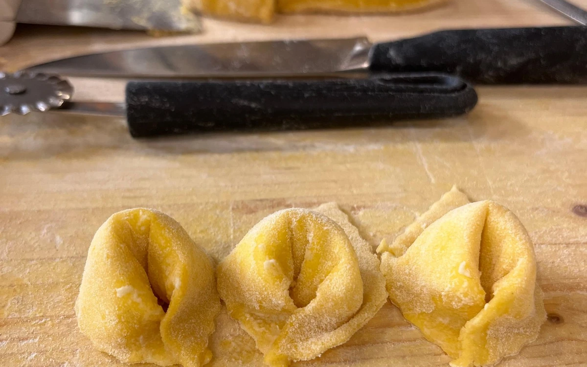 Stuffed pasta folded by hand on a floured board