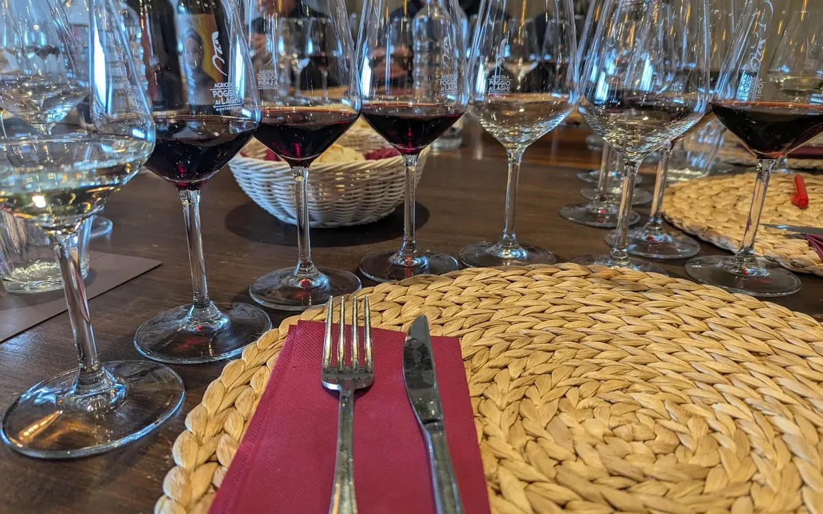 A row of wine glasses on a table laid with woven place mats
